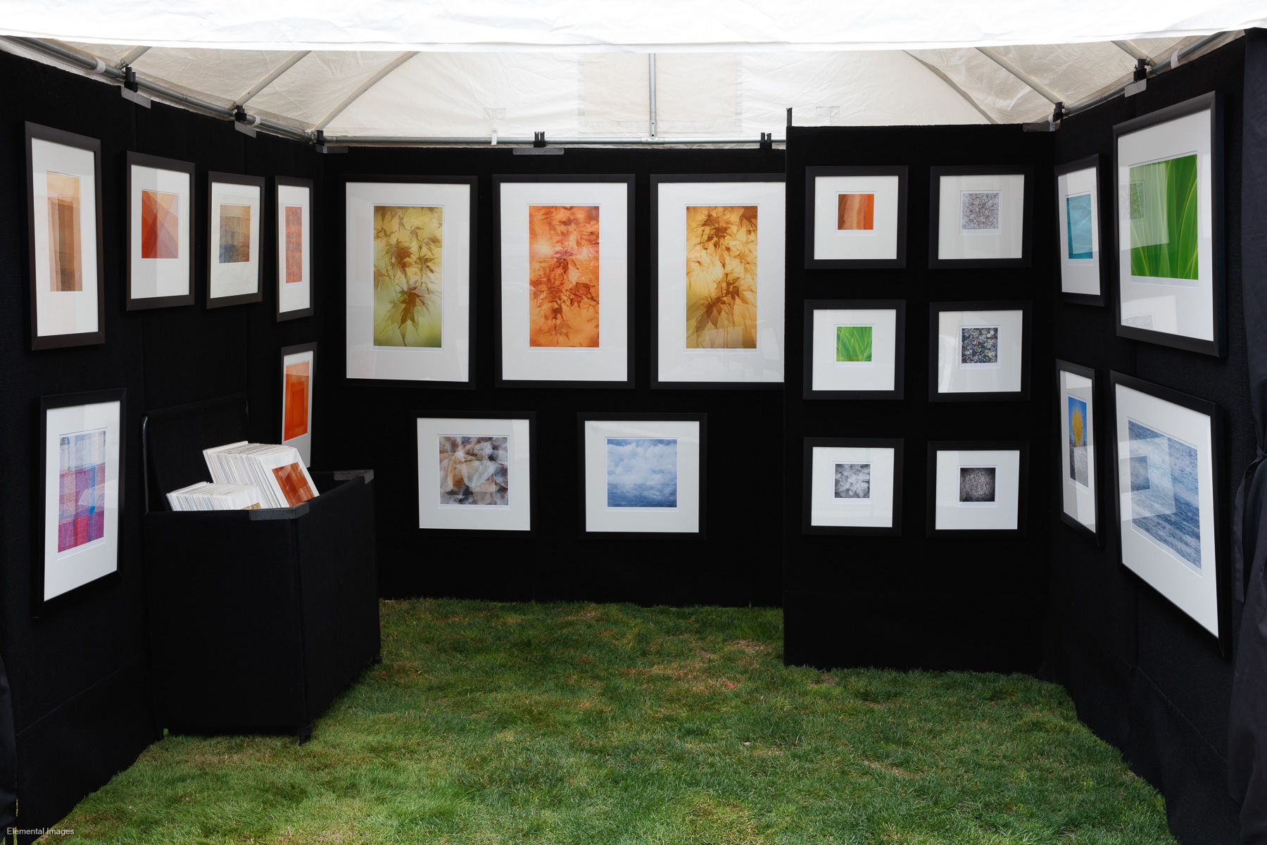 Selection of framed prints on display in outdoor art show booth |  |  |  - © Elemental Images - All Rights Reserved Worldwide