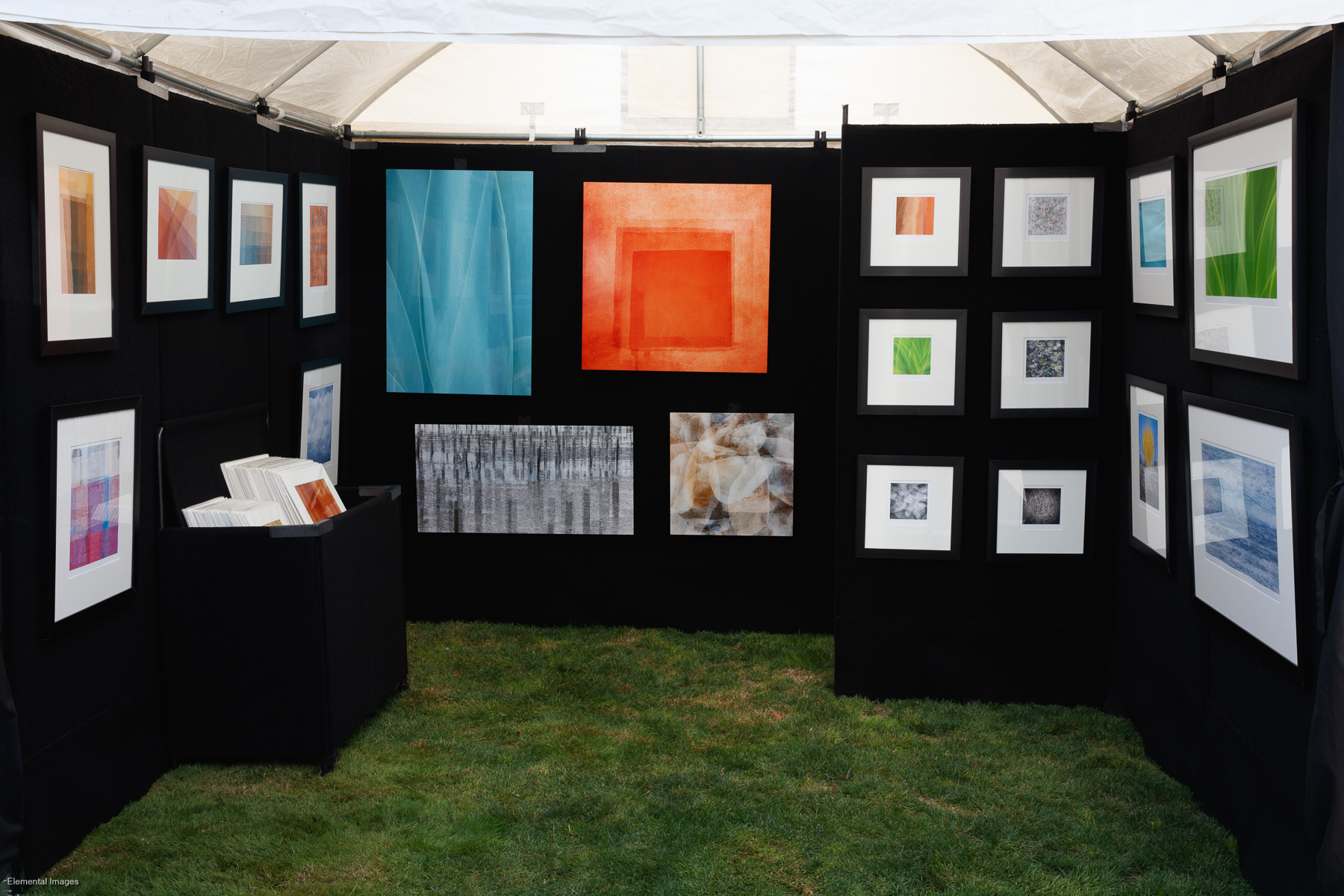 Selection of prints on display in outdoor art show booth |  |  |  - © Elemental Images - All Rights Reserved Worldwide